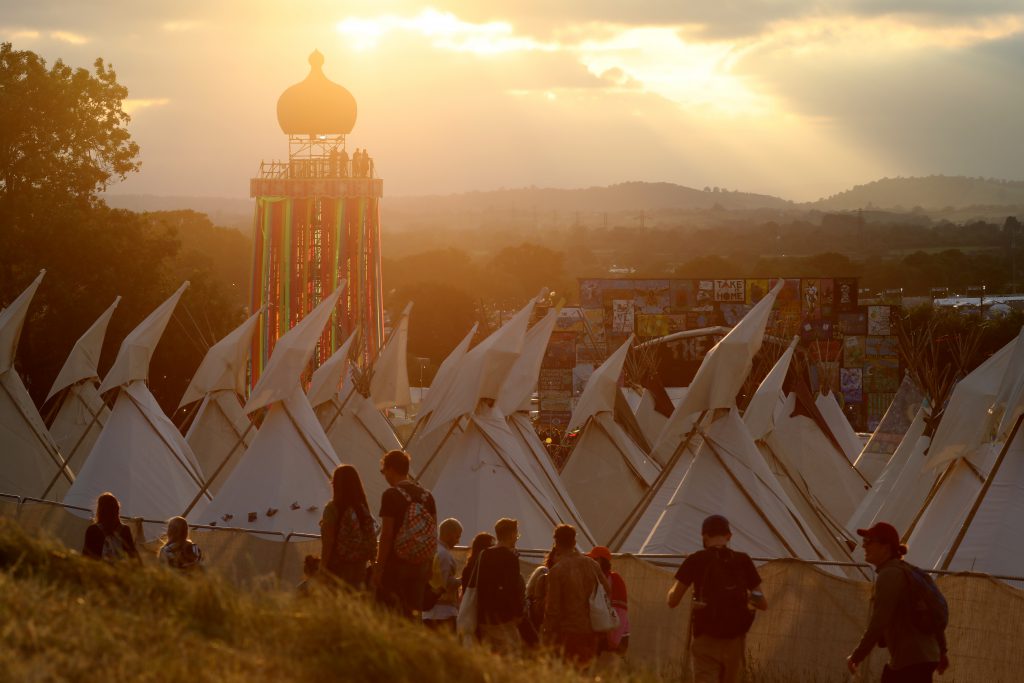 2019Festival AnnaMatt 25 Glastonbury sunbeam over ribbon tower and tipis