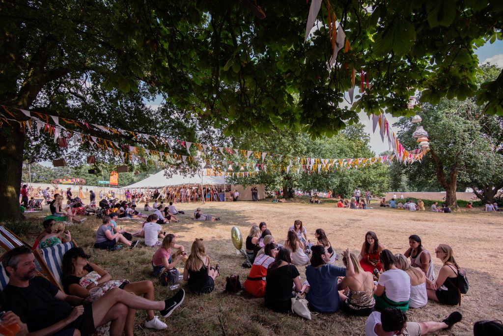 Kaleidoscope Festival attendees sitting in shade