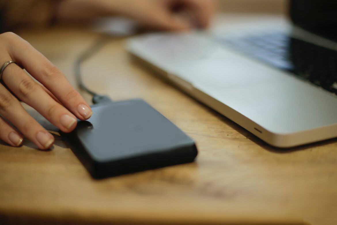 black square device on brown wooden table