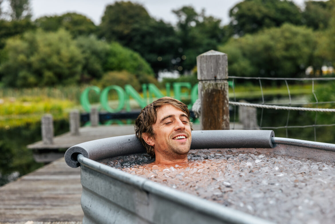 Connect Festival Cold Water Therapy with sign in background