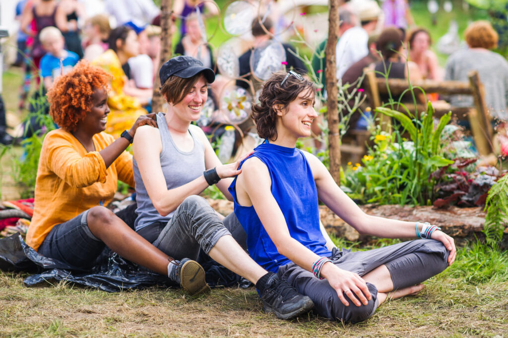 People sat on grass at Shambala