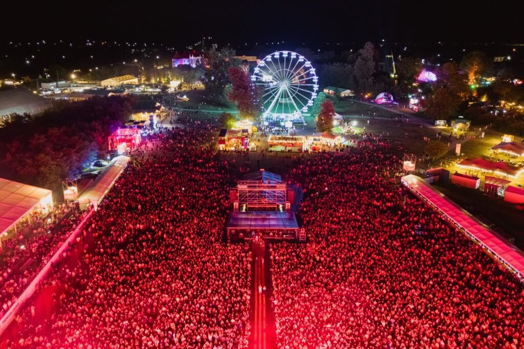 Electric Castle aerial shot of ferris wheel and crowd at night