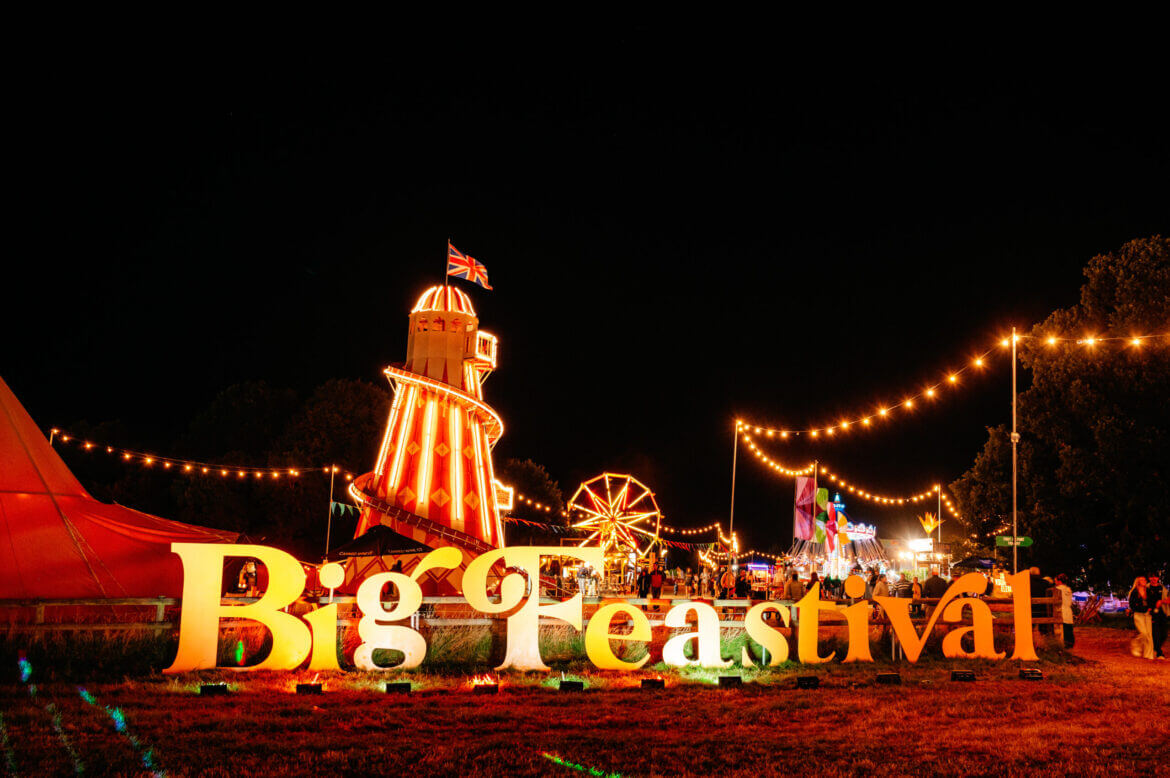 Big Feastival sign and helter skelter at night