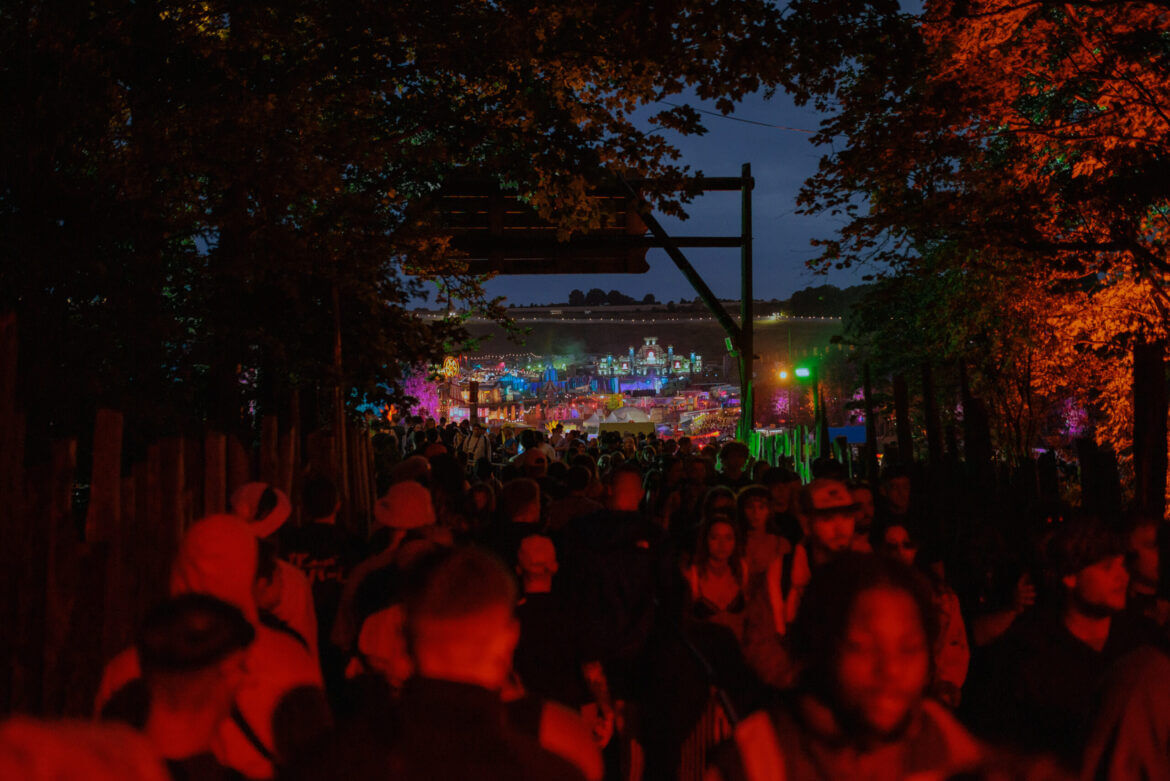 Boomtown Fair 2024 crowd entering downtown at night