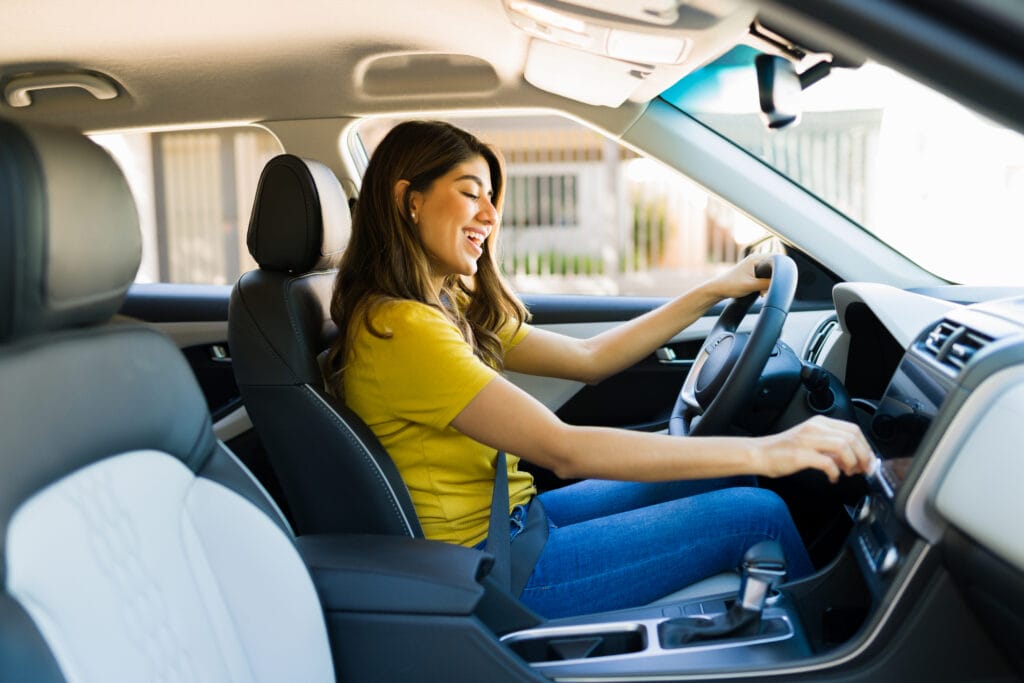 43 percent like modern music Cheerful young woman singing in the car while driving and listening to music on the radio