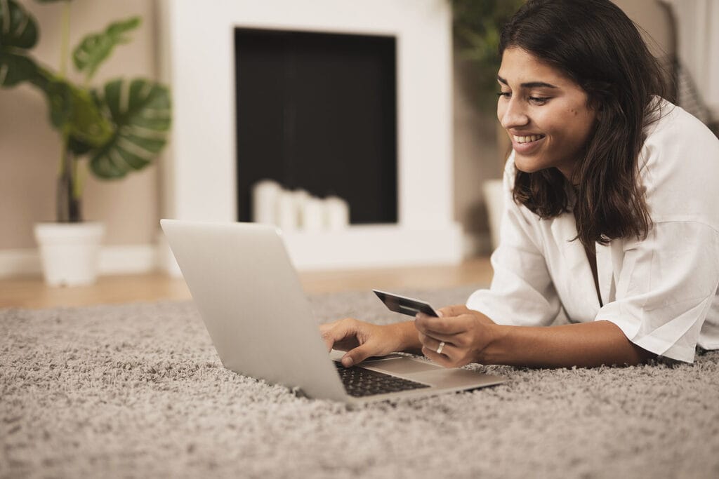 woman sitting floor holding credit card woman sitting floor holding credit card