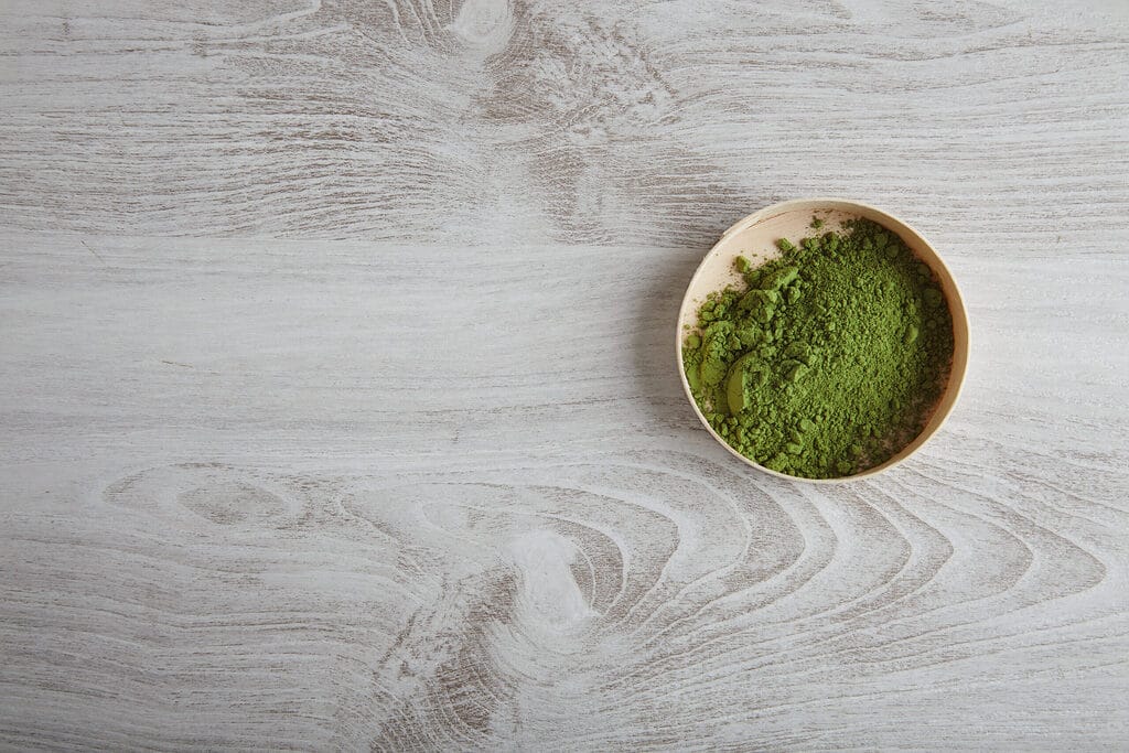 top view organic premium matcha tea powder wooden box isolated white simple table alone top view organic premium matcha tea powder wooden box isolated white simple table alone