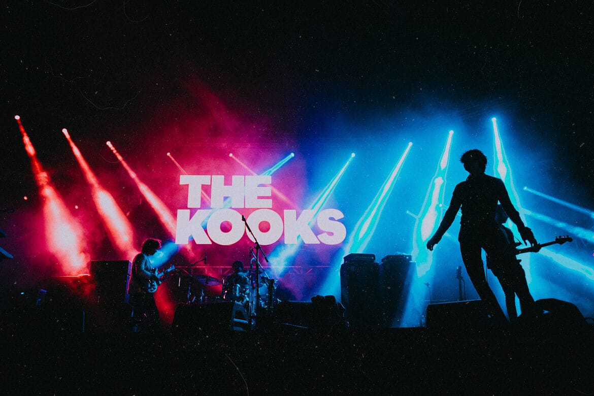The Kooks live on stage with logo backdrop