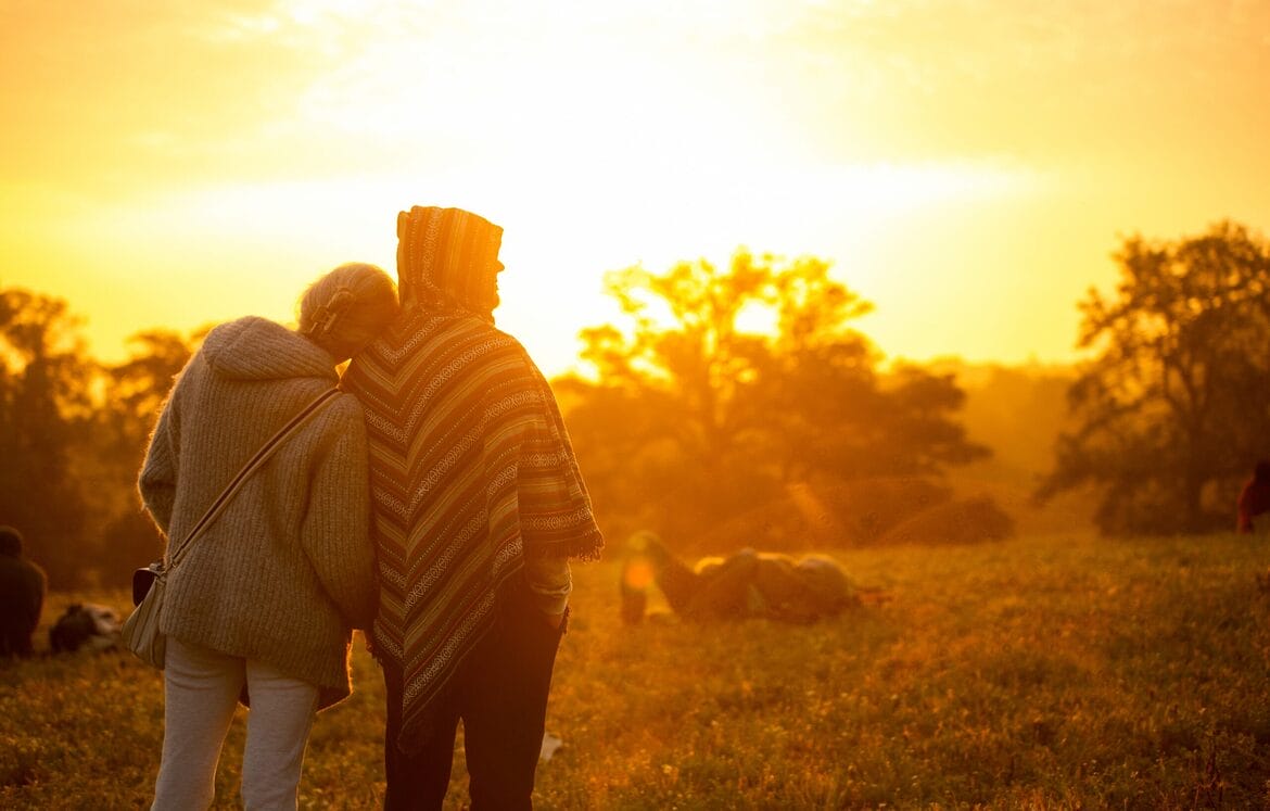 Couple looking at sunrise at Solstice at Wasing Sunrise Ceremony