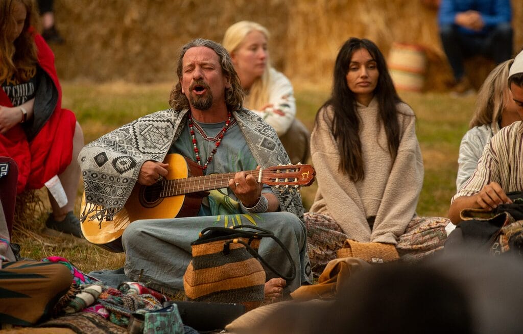 Man playing guitar at Solstice at Wasing Sunrise Ceremony