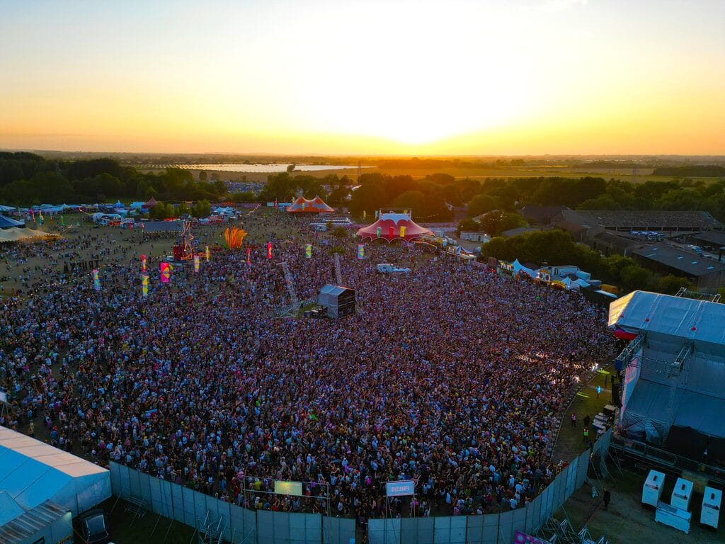 truck festival drone shot Drone shot of Truck Festival main arena and main stage crowd at sunset