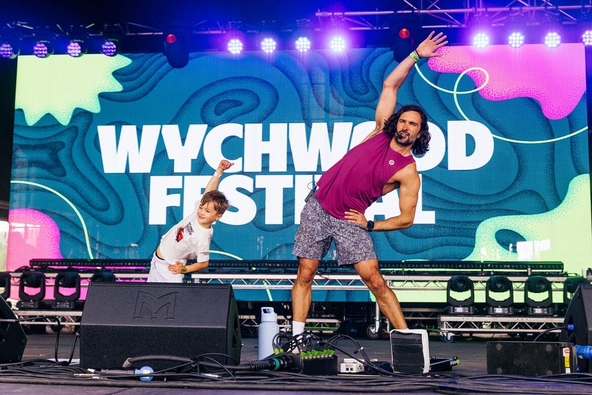 Wychwood joe wicks on stage with sign behind