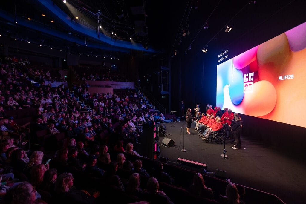 Lifi25 people on stage showing auditorium scale
