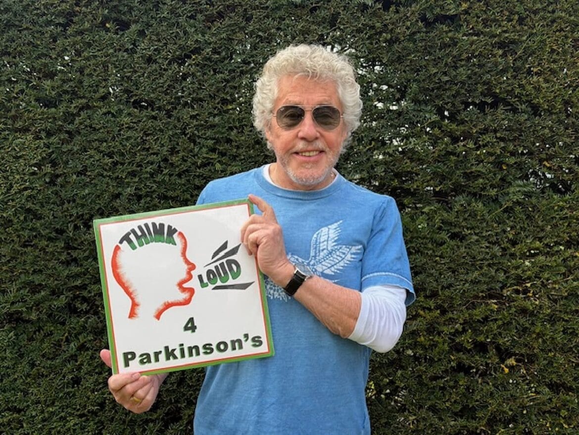 Sir Roger Daltrey holding a copy of Think Loud 4 Parkinsons