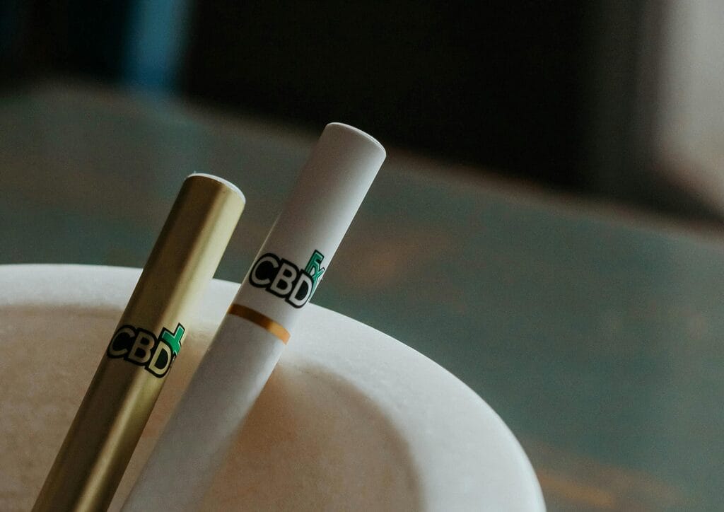 Row of THC vape cartridges arranged on a neutral background