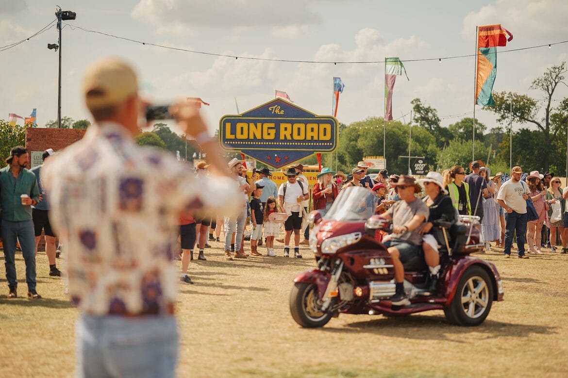 The Long Road Festival Harley Ride Through with festival sign
